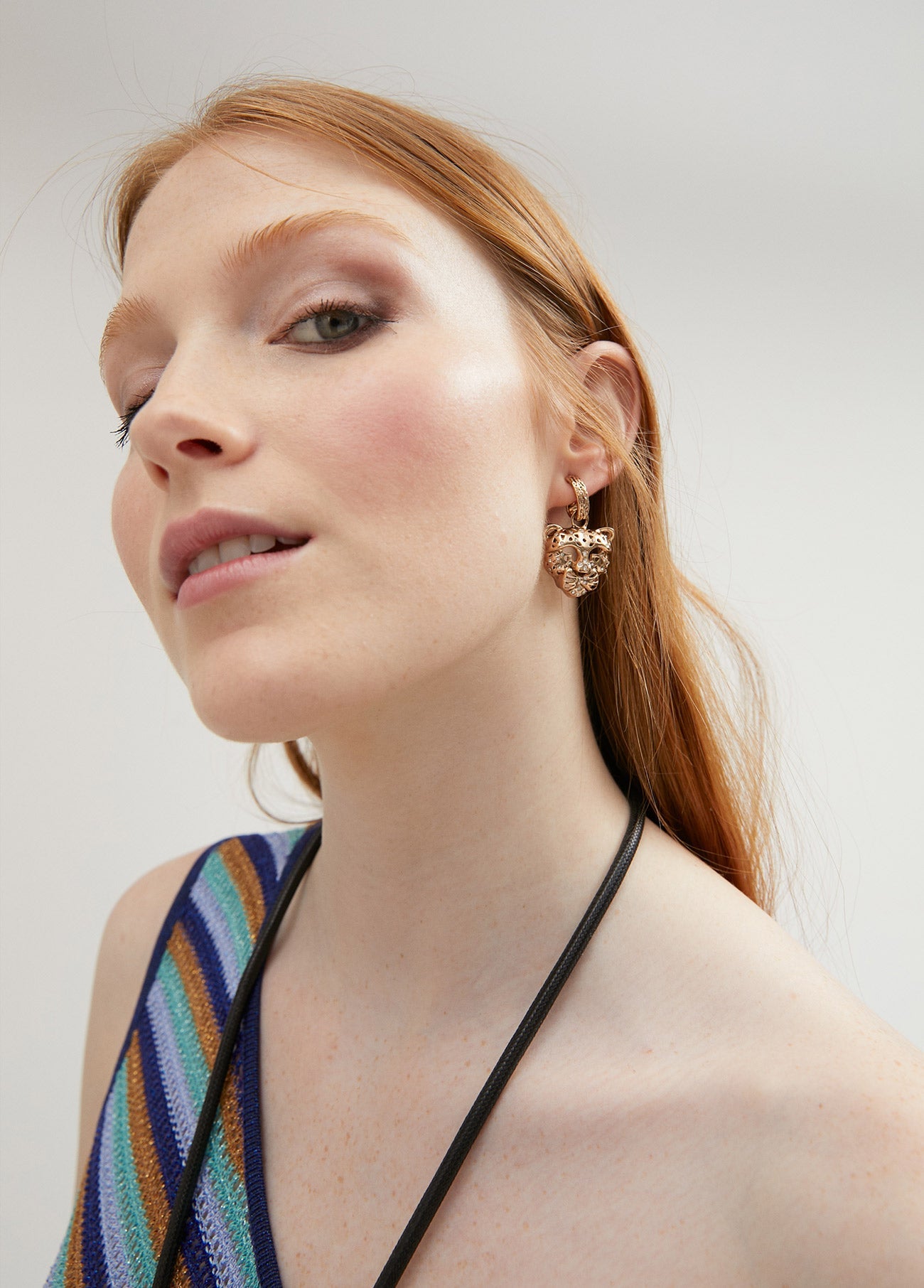Gold-toned tiger’s head earrings