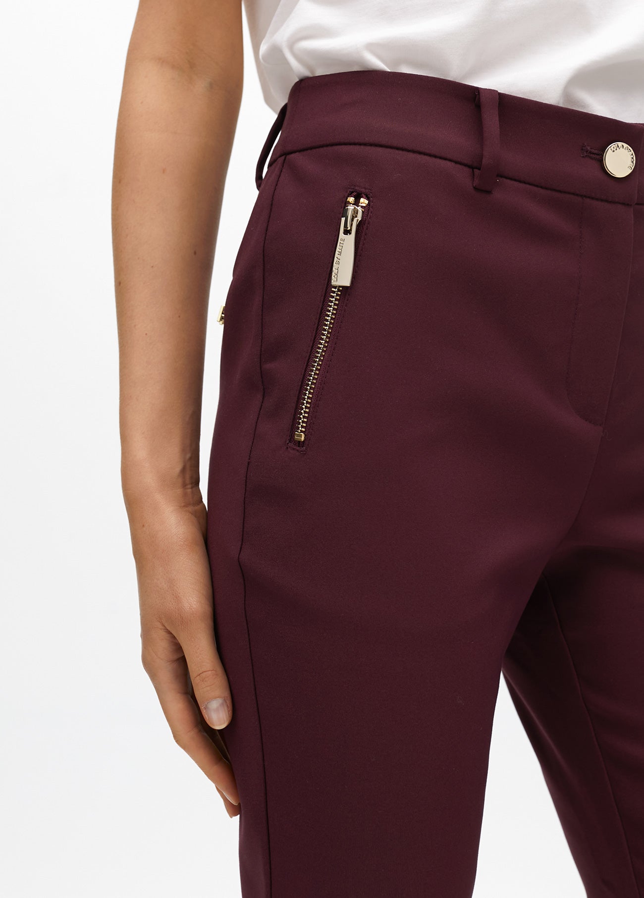 Stretch fabric trousers with zipped pocket