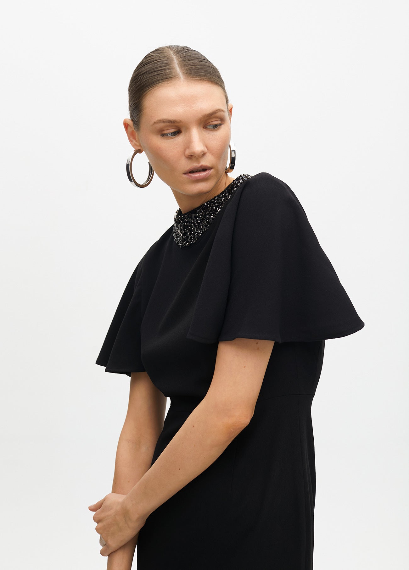 Dress with cape sleeves and a rhinestone collar